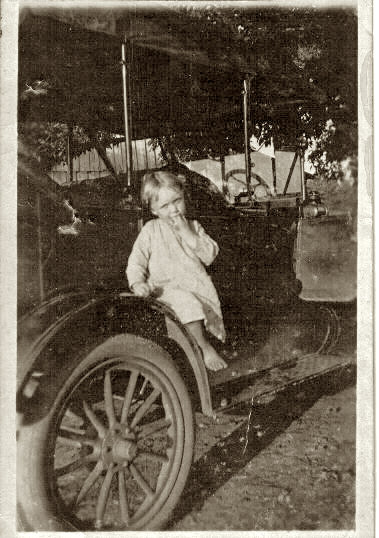My grandmother Lorene Dodd on the fender of her father's car in 1917. Athens, Alabama.